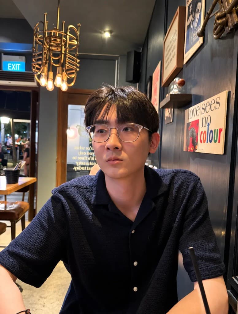 Jovan sitting in a warmly lit cafe