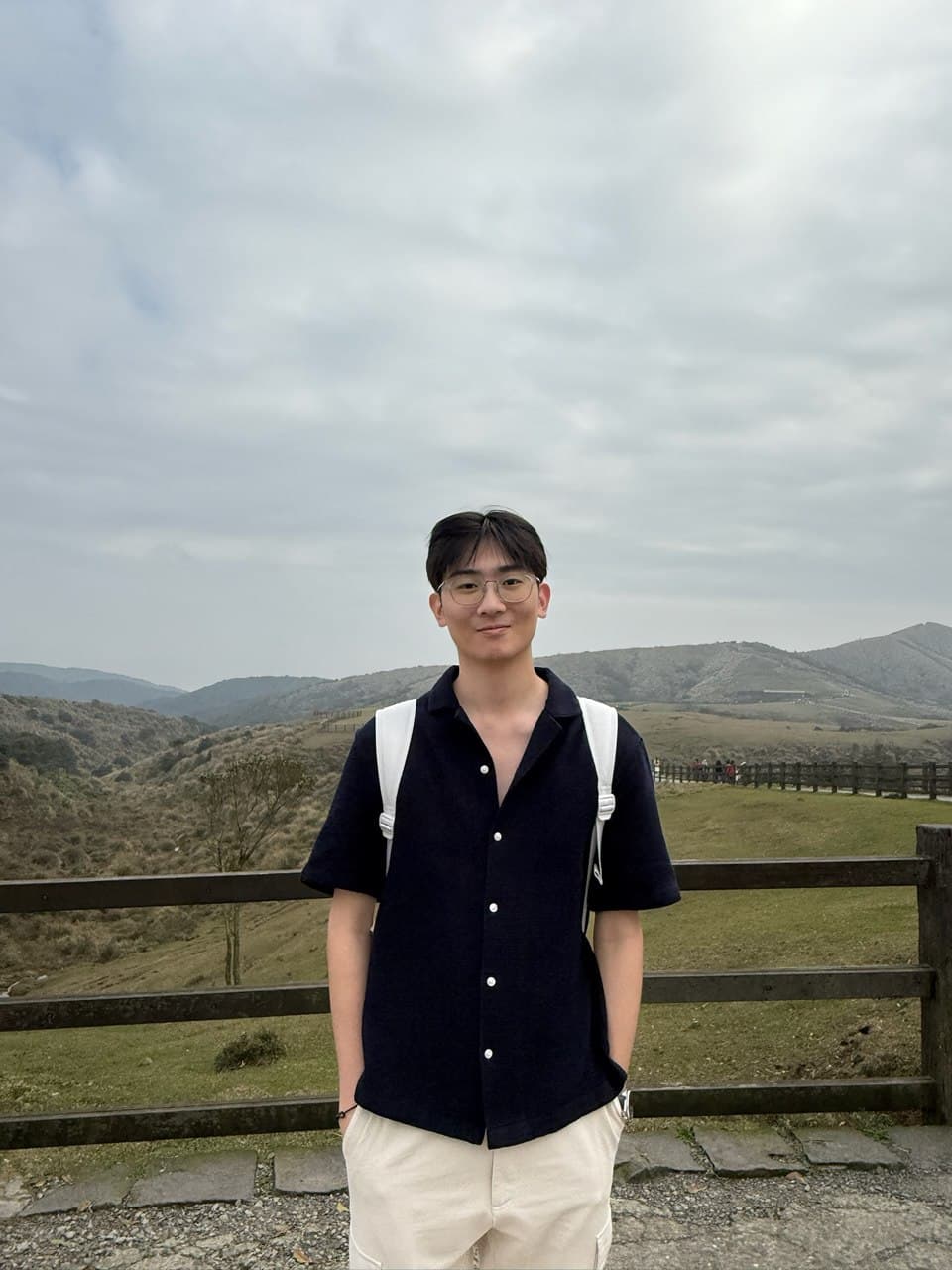 Jovan standing in front of a mountain landscape